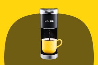 Stock image of the Keurig Mini Coffee maker in back with a yellow coffee mug