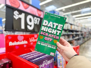 hand holding date night scratch off in walmart aisle