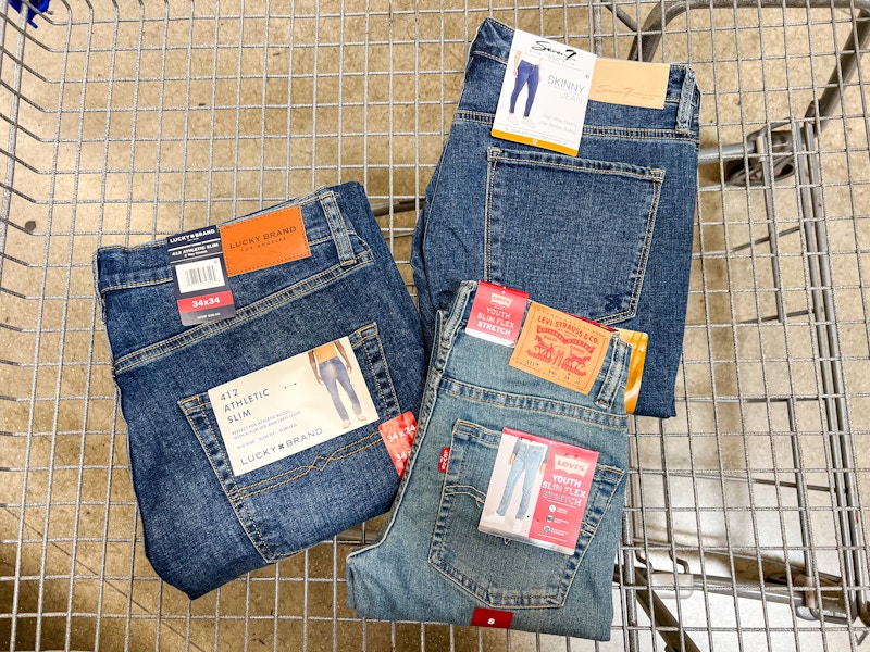 3 pairs of jeans in a cart