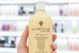 hand holding hairitage shampoo