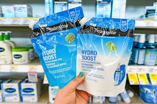hand holding two packs of neutrogena gel cleanser refills