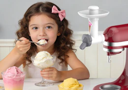 a kid eating ice cream next to a mixer with an ice cream attachment