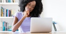 skeptical person at home looking at laptop