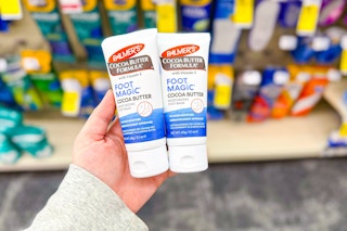 person holding 2 palmers foot creams