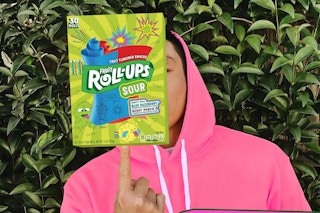Person holding up Fruit roll up sour