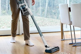 a shark cordless vacuum cleaning up cereal