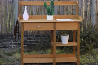 lifestyle image of a wooden gardening bench
