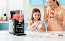 a mom and daughter eating ice cream next to a slushie machine