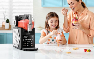 a mom and daughter eating ice cream next to a slushie machine