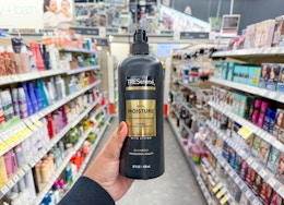 hand holding tresemme shampoo in walgreens