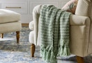 studio mcgee throw blanket sitting on a chair
