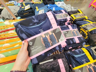 hand holding a 2-pack of womens' active tank tops