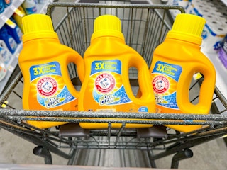 bottles of arm & hammer laundry detergent in a shopping cart