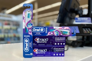 crest 3d white stain eraser toothpaste and oral-b vivid whitening toothbrush on a checkout counter