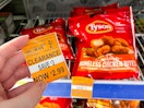 hand holding a clearance tag with tyson boneless chicken bites in the background