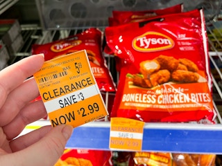 hand holding a clearance tag with tyson boneless chicken bites in the background