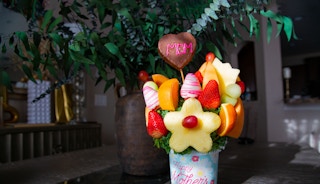 Fruit bouquet with pineapples grapes cantaloupe and chocolate cover fruit