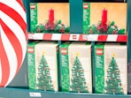 christmas lego sets sitting on a shelf at target