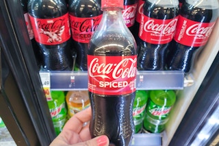 hand holding a bottle of coca cola spiced soda at kroger