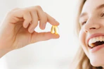 a person holding two softgels