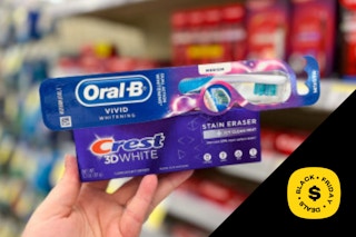 hand holding toothbrush and toothpaste