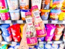 hand holding two bottles of skinny mixes in walmart aisle
