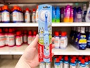 hand holding a colgate bluey battery-powered toothbrush at target