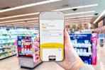 hand holding a smartphone displaying a 1-clip coupon in the kcl app