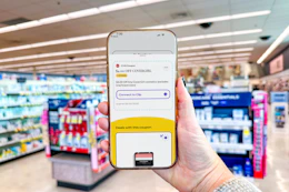 hand holding a smartphone displaying a 1-clip coupon in the kcl app