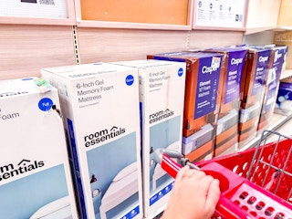 target cart parked in front of mattresses sitting on a target shelf