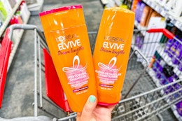 hand holding a bottle of L'Oreal Elvive shampoo and conditioner