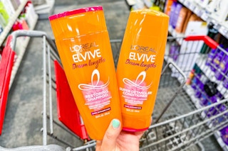 hand holding a bottle of L'Oreal Elvive shampoo and conditioner