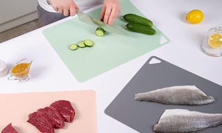 three color cutting boards with food on them