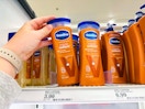 hand grabbing a bottle of Vaseline lotion off the shelf at a store