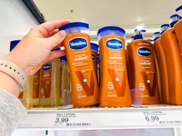 hand grabbing a bottle of Vaseline lotion off the shelf at a store