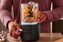 a man using a kitchenaid food chopper