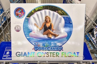 giant oyster pool float in a cart