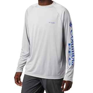 A guy modeling a grey t-shirt on a white background