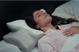 Woman sleeping on memory foam pillow.