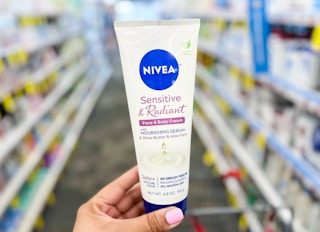 hand holding bottle of Nivea cream