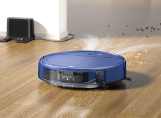 a blue robot vacuum on hardwood floor