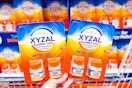 hand holding packs of xyzal