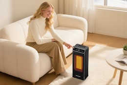 woman turning on heater in the middle of living room