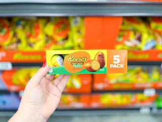 hand holding a 5-count pack of Reeses's eggs