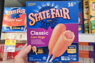 hand holding a box of state fair corn dogs