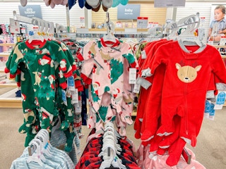 carter's christmas jammies hanging on a rack