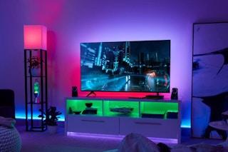 colorful lights around a TV and TV stand in a room 