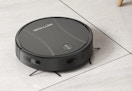 black robot vacuum and mop cleaning the floor