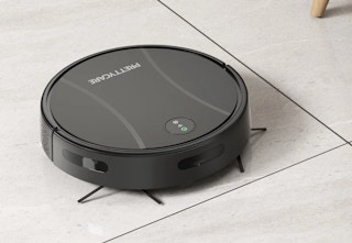 black robot vacuum and mop cleaning the floor