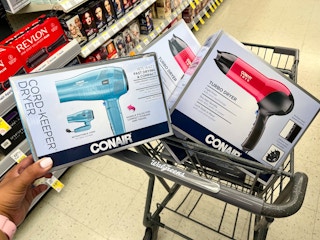 hand putting blow dryer in shopping cart